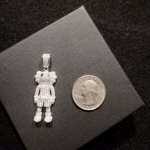 925 sterling silver KAWS pendant iced out with cz stones.